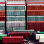 Close,Up,Image,Of,Stacked,Containers,And,Trailer