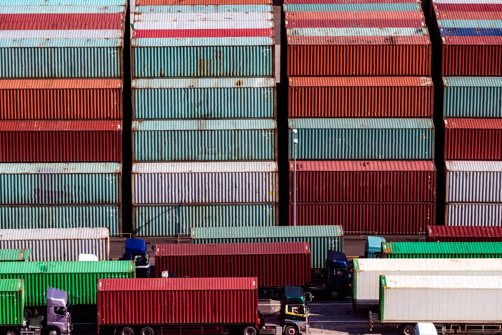 Close,Up,Image,Of,Stacked,Containers,And,Trailer