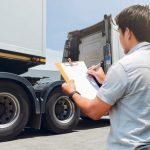 Truck,Driver,Holding,Clipboard,Is,Checking,The,Truck's,Safety,Maintenance